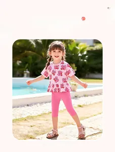Close-up of pink cherry and bow print on girls cotton summer top and leggings set