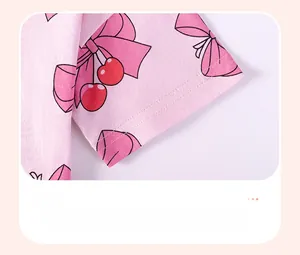 Close-up of pink toddler top sleeve with cherry bow prints and double stitching