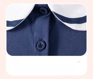 Close-up of navy blue girls' dress with white sailor collar and two buttons