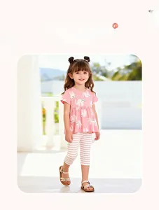 Detail of pink cotton T-shirt with cat print and matching striped pants for little girls