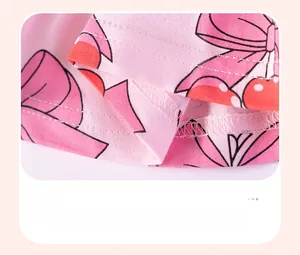 Detail of baby girl summer outfit showing smooth hem stitching and cherry print