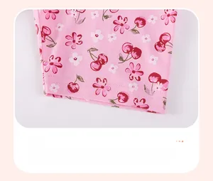 Detail of pink cotton shorts with cherry floral print and durable double-stitched hem