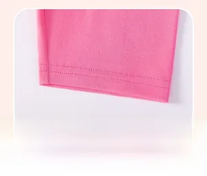 Detail of pink cotton fabric showing high-quality double-needle stitching on the hem