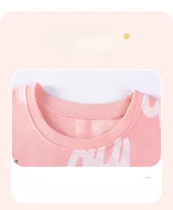 Close-up of pink knit top neckline with ribbed edges and soft cloud patterns