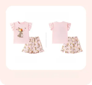 Detail of pink cotton girl pajamas set with rabbit prints and ruffled sleeve edges
