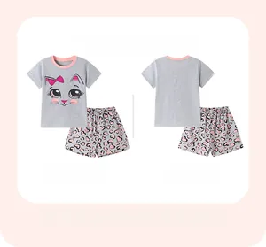 Detail view of cotton kids pajamas with cat print and pink heart pattern shorts