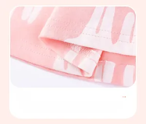 Close-up of pink cotton knit fabric showing precise double-needle hem stitching detail