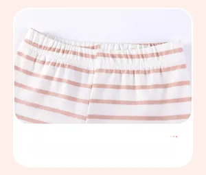 Detail of baby girl striped cotton pants featuring an elastic waistband for comfort