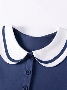 Navy blue girls short sleeve dress featuring a white sailor collar with striped details