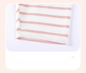 Close-up of pink striped cotton pants showing high-quality stitching on the cuffs