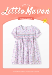 Detail of smocked chest and purple floral print on short sleeve girls cotton dress