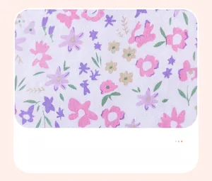 Close-up of floral print fabric with pink and purple blossoms for girls' summer dress