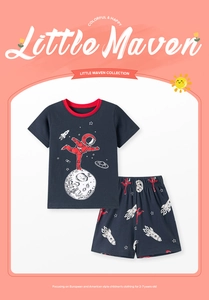 Detail of boys' navy cotton pajamas with red astronaut and space-themed cartoon prints