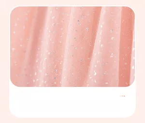Close-up of pink tulle fabric with silver sequins and pleats on a girls princess dress