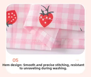 Détail de l'imprimé fraise sur vichy rose avec coutures fines sur l'ourlet de la robe