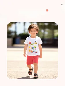 Detailed outdoor shot of boys summer outfit with cartoon vehicle print and red shorts