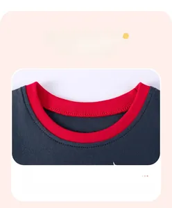 Detail of the crew neck collar with red contrast ribbing on a dark gray cotton kid's shirt