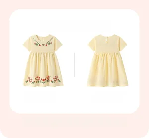 Detail of cream short sleeve baby dress showing floral embroidery and back button closure