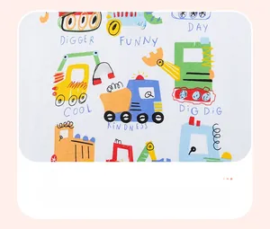 Close-up of baby boy summer cotton fabric with colorful excavator and truck prints
