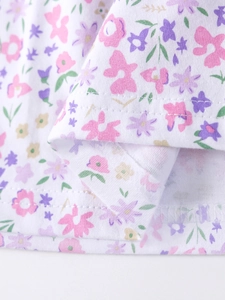 Short sleeve summer dress for girls featuring a vibrant floral pattern on white cotton fabric