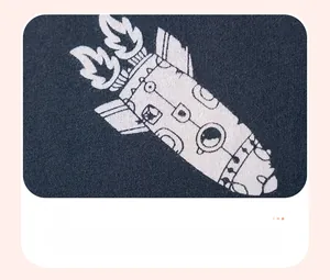 Detailed view of soft cotton fabric and cartoon rocket screen print on navy t-shirt