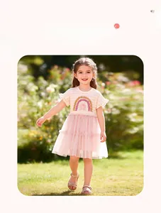 Detail of pink striped bodice with rainbow embroidery and ruffled mesh layers on a girl's dress