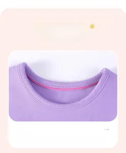 Detail view of the purple crew neck stitching and inner pink lining on girls cotton top