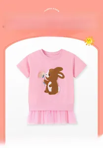 Detail of pink girls' dress showing fuzzy brown rabbit patch with flower and mesh tutu hem