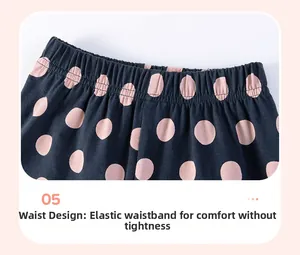 Detail of elastic waist on navy blue leggings featuring a cute pink polka dot pattern