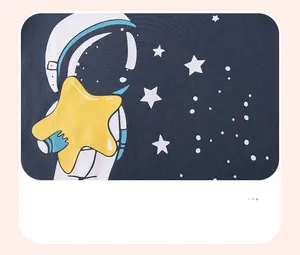 Close-up of boys cotton outfit showing starry space astronaut and stars pattern print