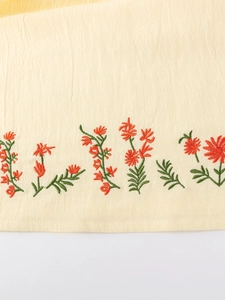 Short sleeve girls dress in off-white with delicate orange floral embroidery details