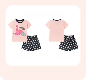 Front and back view of pink dinosaur cotton T-shirt and navy polka dot shorts set