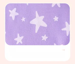 Close-up of soft purple cotton fabric featuring a white star pattern for kids' clothing