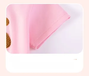 Close-up of pink short-sleeve cuff with bear ear applique and durable double stitching