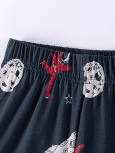 Navy blue kids' pajama pants featuring astronaut and space print with elastic waist