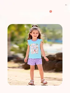 Girl's summer casual set with unicorn sleeveless top and star print shorts on beach