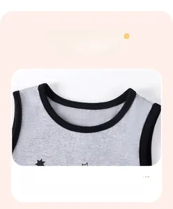 Close-up of boys gray knit vest with black star pattern and ribbed crew neck details
