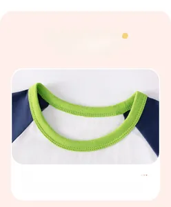 Macro detail of kids cotton t-shirt with contrast green ribbed neckline and double stitching
