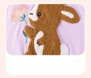 Detail of chenille rabbit patch with pink flower on purple cotton dress for girls