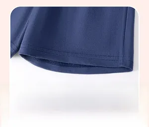 Detail of navy blue knit trousers leg with neat double-needle stitching and fabric texture