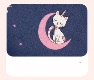 Détail du motif chat sur lune sur tissu en maille bleu marine pour vêtements d'enfant