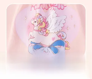 Detail of pink cotton fabric with cartoon unicorn, rainbow print and blue bow decoration