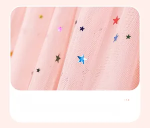 Detail of pink mesh fabric with colorful glitter stars and pleated hem for girls' dress