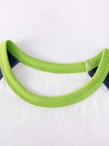 Kids cotton raglan tee with white body, navy sleeves and bright green ribbed neckline