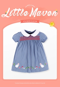 Detail of girls cotton polka dot dress with hand-smocked embroidery and Peter Pan collar