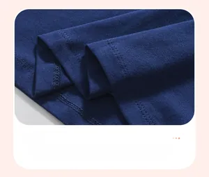 Detail view of the navy blue cotton knit dress hem featuring durable double-stitch sewing