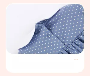 Detail of baby girl cotton dress with white Peter Pan collar and polka dot pattern
