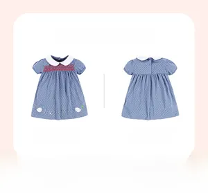 Front and back view of girls blue polka dot dress with smocking and bunny embroidery