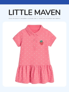 Detail of pink polka dot polo dress featuring a small red strawberry embroidery on chest