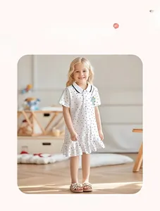 Detail of white polka dot polo dress with unicorn embroidery and Peter Pan collar